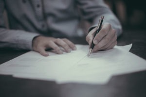 Person-signing-Some-Documents-With-A-Fancy-Pen